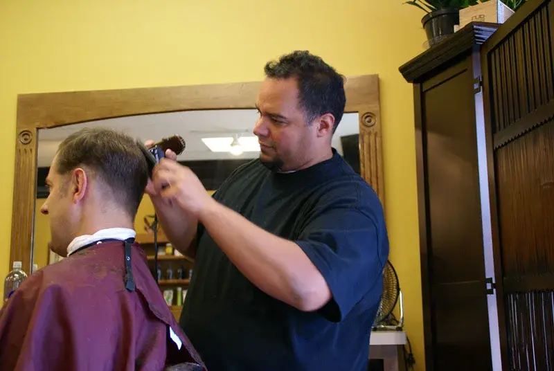 Clipper haircut in progress at Wheaton Barber Shop of Winfield IL