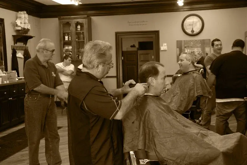 Busy day — barbers cutting hair at Wheaton Barber Shop in DuPage County