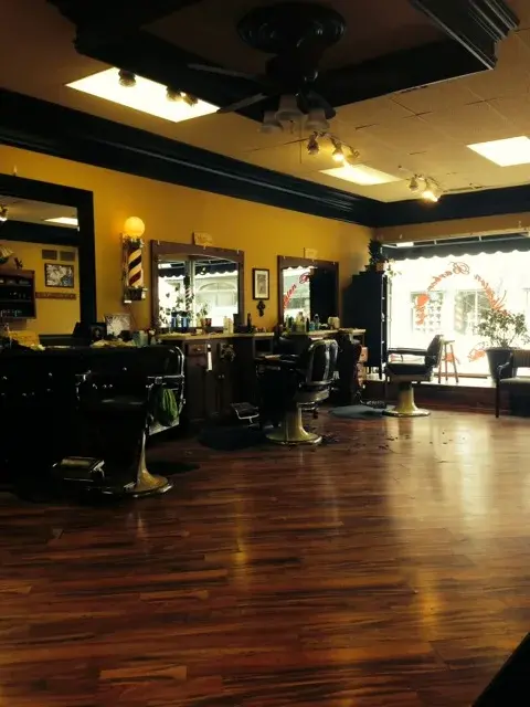 Wheaton Barber Shop interior — barber chairs, mirrors, and polished hardwood floors