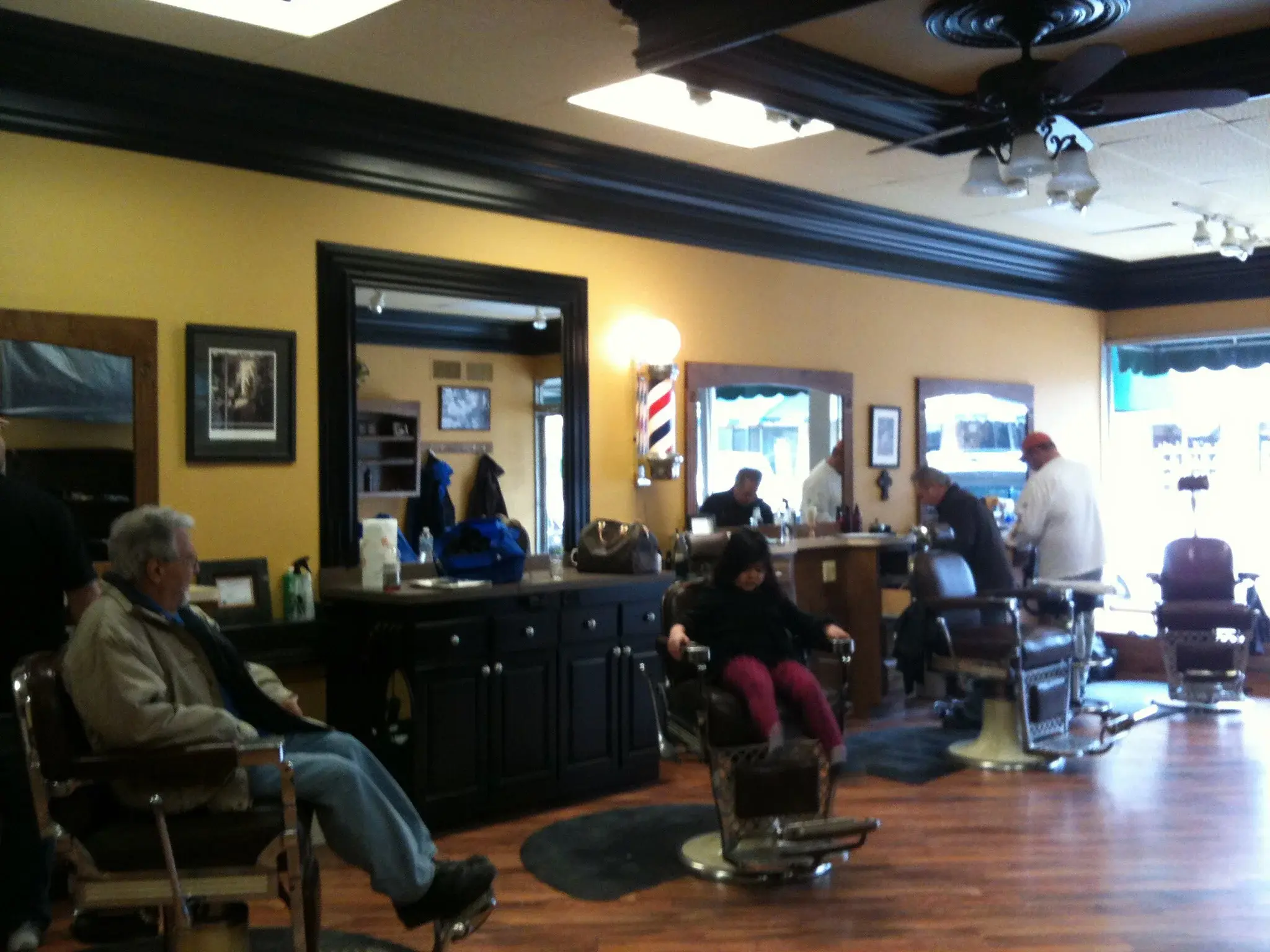 Customers and barbers gathered outside Wheaton Barber Shop in Winfield