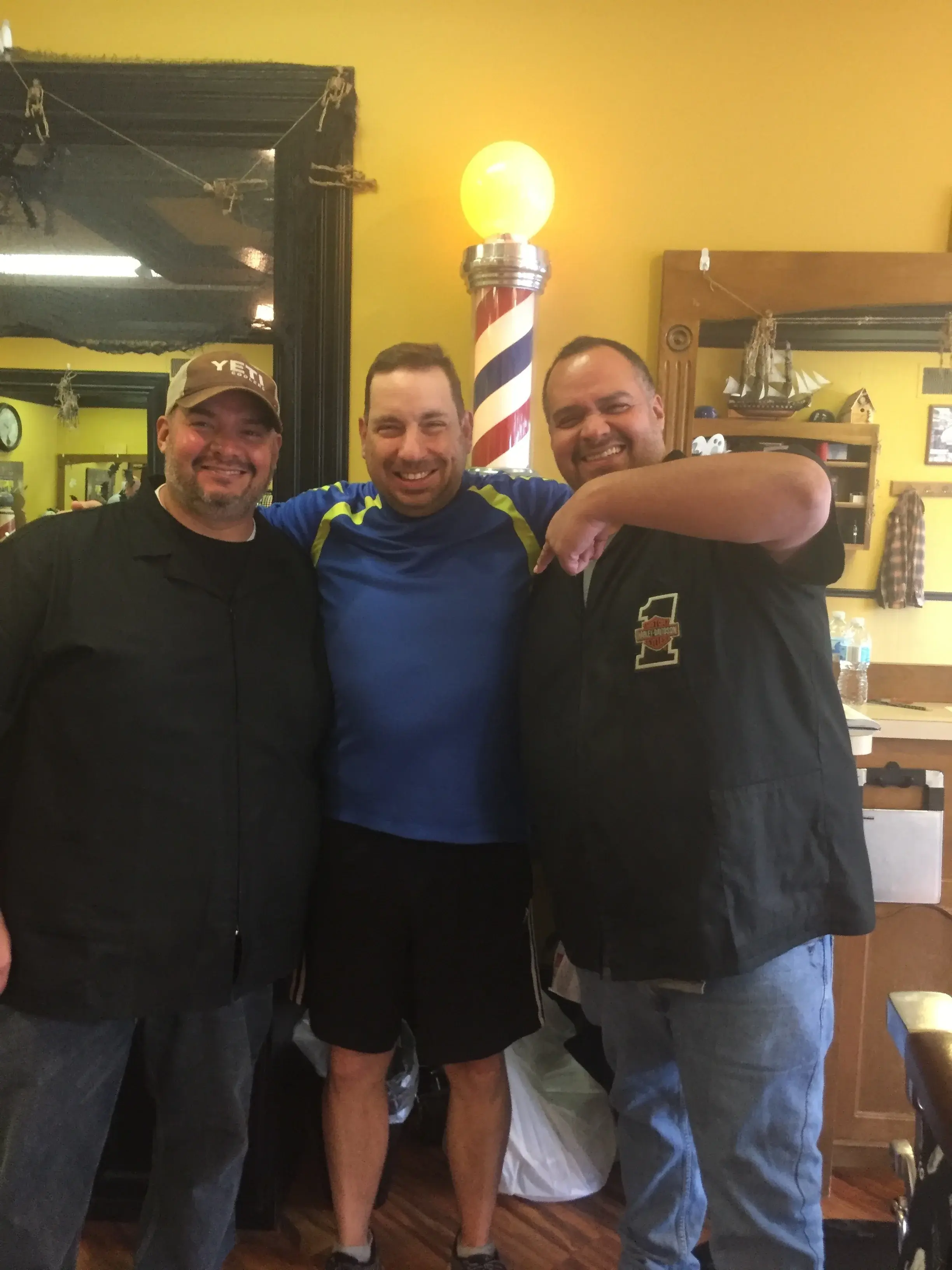 Wheaton Barber Shop barbers posing with a happy customer in Winfield IL
