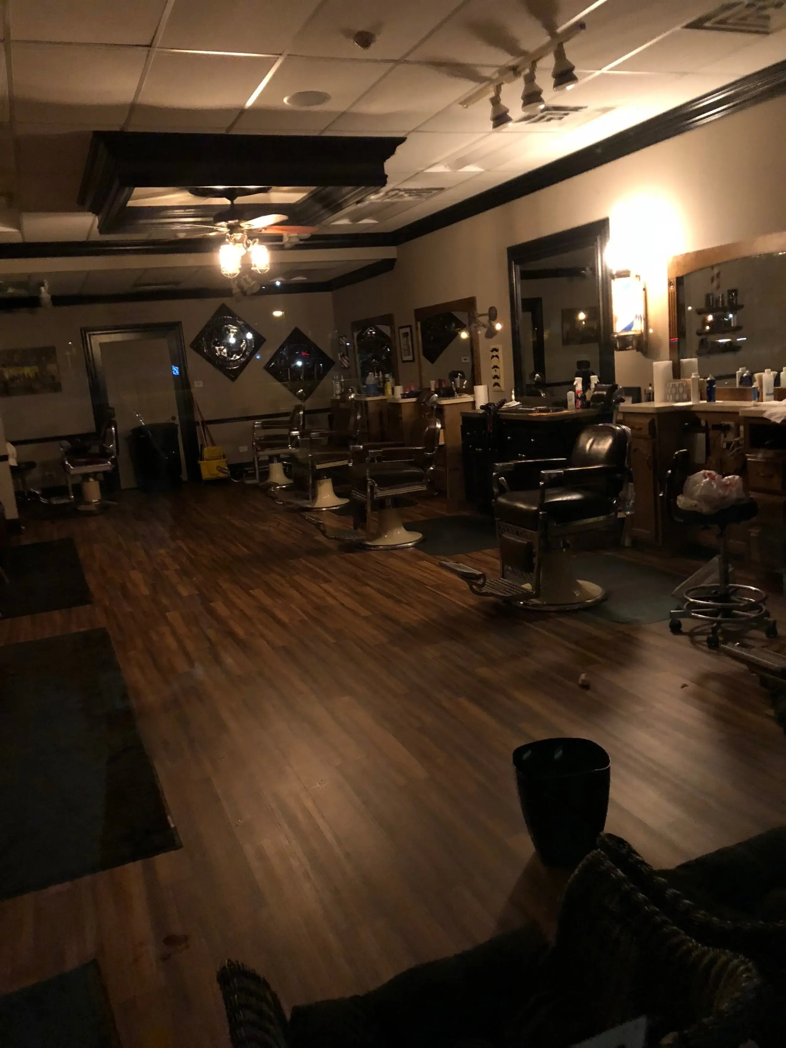 Wheaton Barber Shop interior with vintage barber chairs and warm lighting