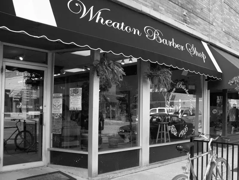 Historic black and white photo of the Wheaton Barber Shop storefront